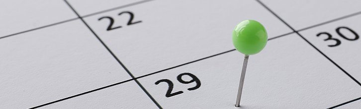 Kalender mit einem grünen Pin